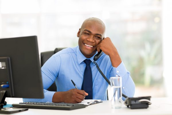 Cheerful,African,American,Businessman,Talking,On,Phone,In,The,Office